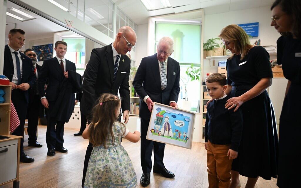 King Charles III (centre) is presented with a painting from children thanking him for his visit to the Jewish Community Centre (JCC) Krakow, to meet Holocaust survivors and hear from volunteers and members about the centre's support for people of all ages and backgrounds as part of its mission to rebuild Jewish life in the city. The King is in Poland to attend commemorations at Auschwitz-Birkenau, marking 80 years since the liberation of the concentration camp. Picture date: Monday January 27, 2025. PA Photo. See PA story MEMORIAL Holocaust. Photo credit should read: Victoria Jones/PA Wire