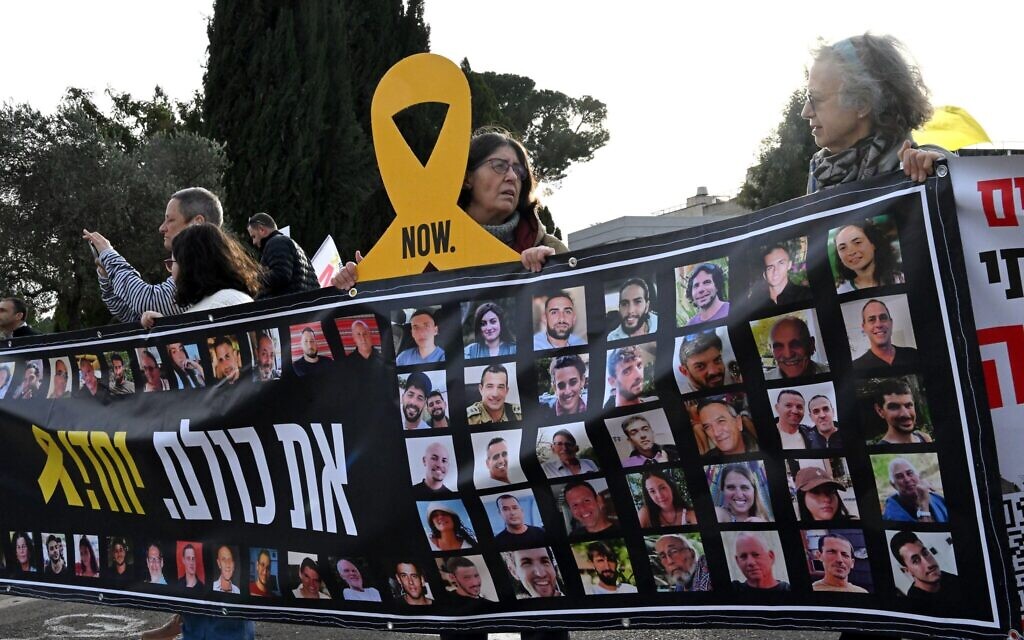 Israelis hold placards of hostages held by Hamas