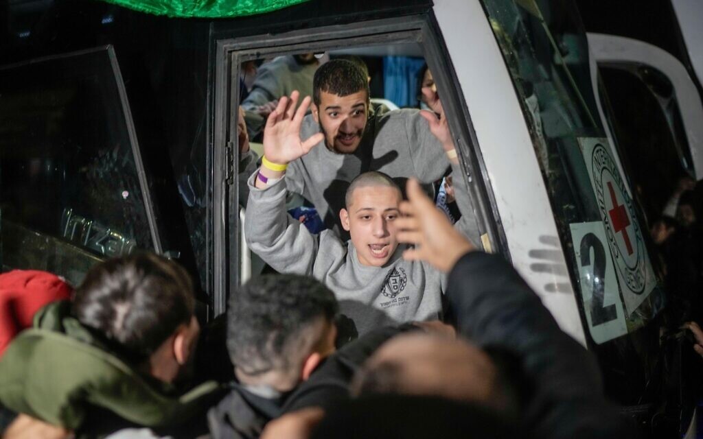 A Palestinian prisoner is greeted as he disembarks from a bus after being released from an Israeli prison, in the West Bank city of Beitunia, early Monday, Jan. 20, 2025. (AP Photo/Leo Correa)