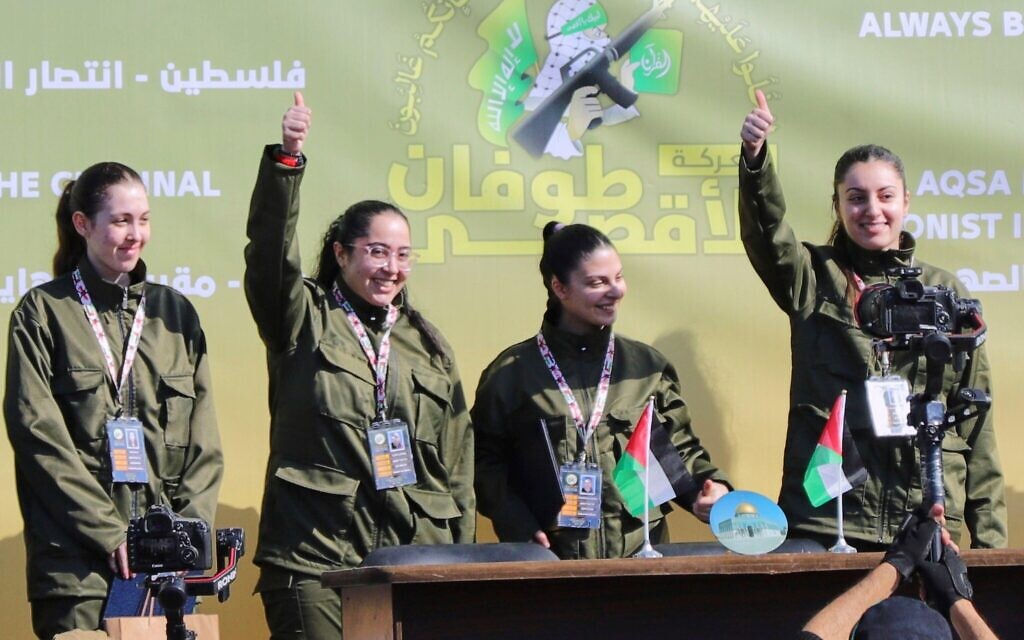 Israeli female soldier hostages wave and react at a Palestinian crowd before being handed over to the Red Cross in Gaza City, Saturday, Jan. 25, 2025. (AP Photo/Abed Hajjar)