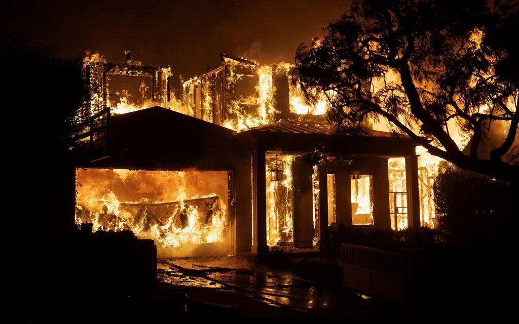A home burns as the Palisades Fire rapidly spreads through the Pacific Palisades neighbourhood in Los Angeles