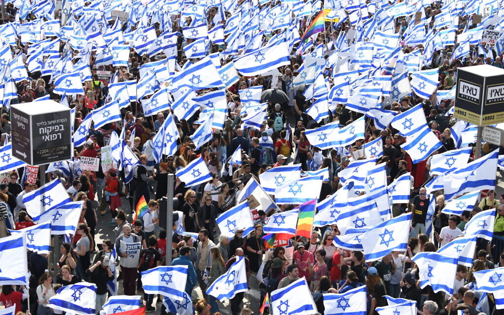 Thousands of Israeli protesters wave flags during a rally against the Israeli government's judicial overhaul bills in Jerusalem, March 27, 2023. (Gili Yaari/Flash90)