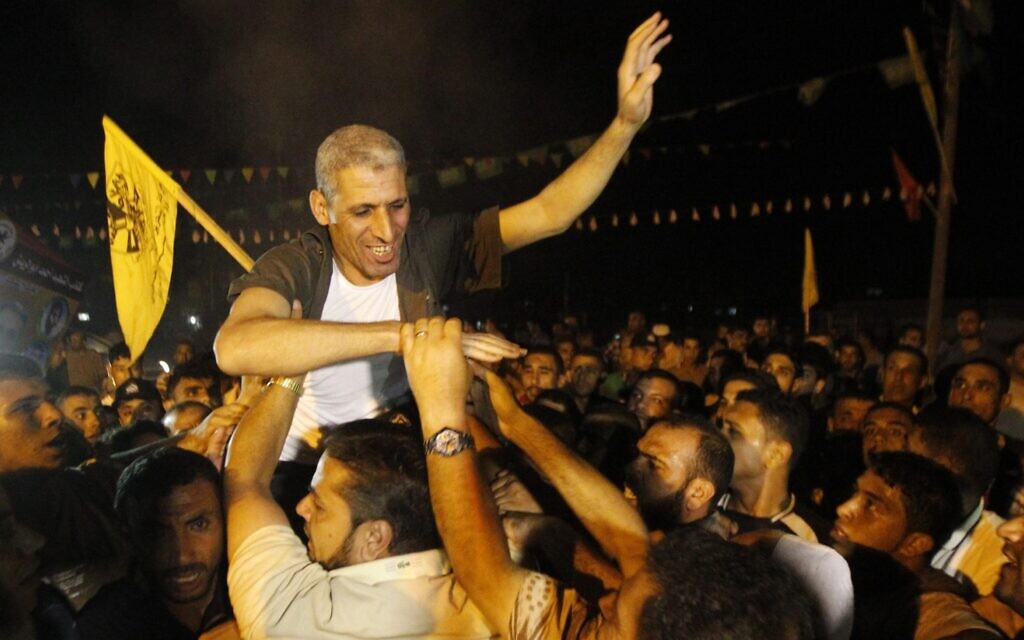 Freed Palestinian prisoner Ateya Abu Moussa, who was held by Israel for 20 years, is greeted by his relatives and friends upon arrival at his family's house in Khan Younis in the southern Gaza Strip, Aug. 14, 2013. (Abed Rahim Khatib / Flash 90)