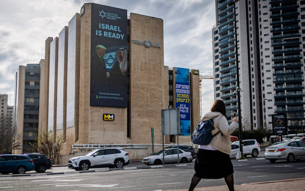 An electronic billboard shows Saudi Crown Prince Mohammed bin Salman shaking hands with U.S. President Donald Trump in Jerusalem, Feb. 3, 2025. (Chaim Goldberg/Flash90)