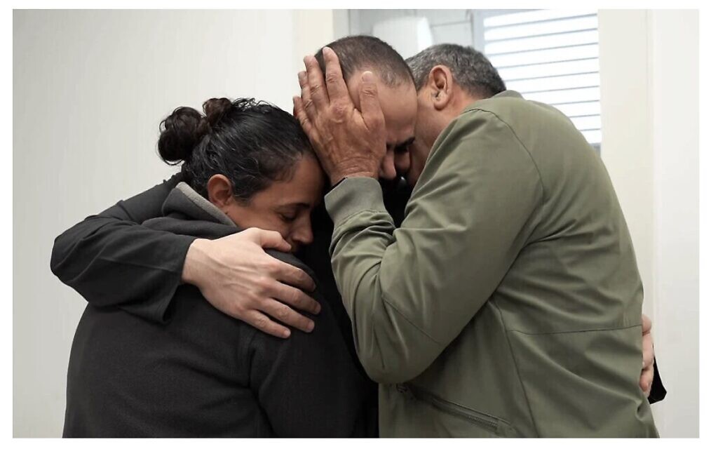Yarden Bibas embraces his father Eli and his sister Ofri at an IDF facility near Re'im after 484 days in Hamas captivity.(Screencapture/Israel Defense Forces)