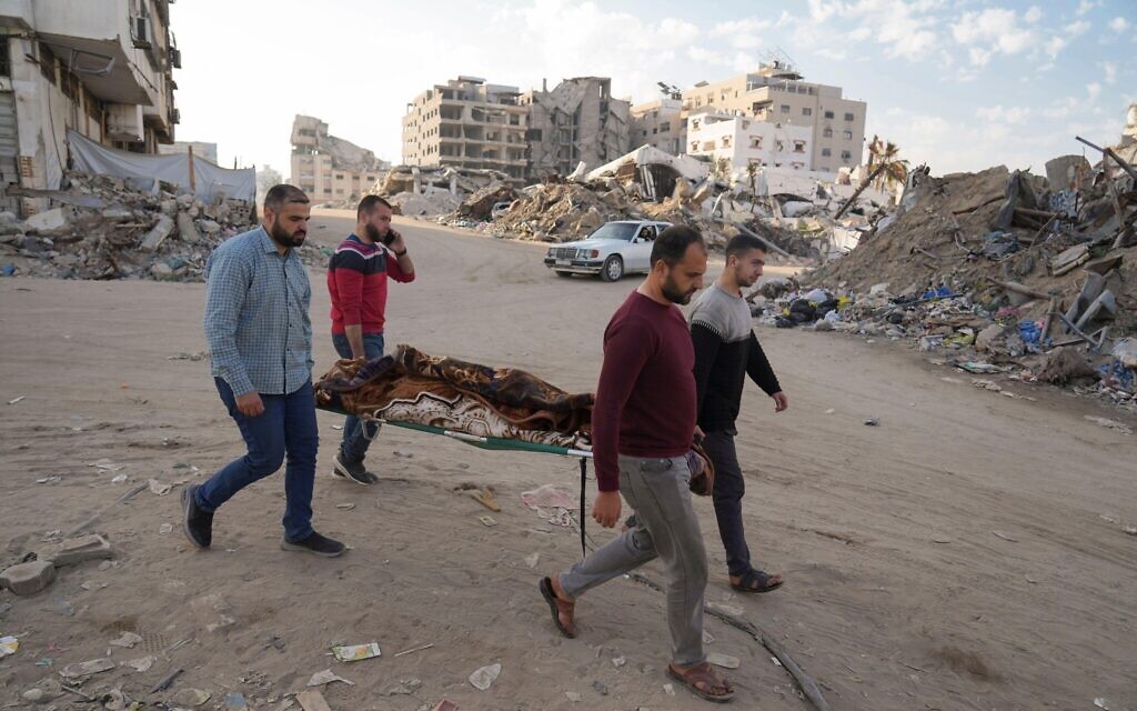 A body of a Palestinian killed in an Israeli army airstrikes is brought to Shifa Hospital in Gaza City, Tuesday, March 18, 2025. (AP Photo/Abdel Kareem Hana)