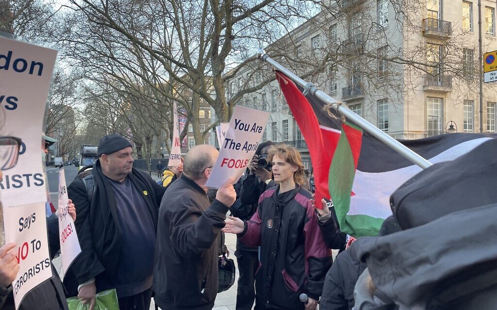 A pro-Palestinian demonstrator faces off with a counter protester holding a sign reading “You Are The April FOOLS!” during a heated exchange outside Senate House Library in London.
