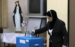 An Israeli Arab casts her vote at a polling station in a previous election. Photo Credit: Reuters An Israeli Arab casts her vote at a polling station in a previous election. Photo Credit: Reuters
