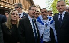 President Isaac Herzog with Poland's President Andrzej Duda and hostage survivor Eli Sharabi, at the gates of Auschwitz for March of the Living 2025. Pic: Twitter/X