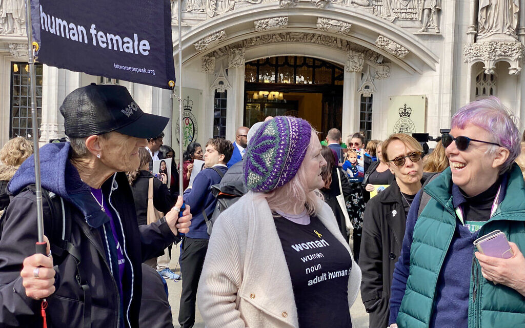 Supporters of the Supreme Court ruling gather outside court holding signs and wearing slogan T-shirts defining “woman” as “adult human female.” Photo taken from X.