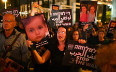Protesters in Tel Aviv hold photos of children killed in the conflict. (Photo Credit: Gili Getz/X)