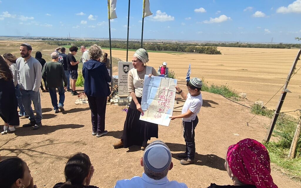 Arbel Zak, a senior Nachala leader, holds a map of envisioned settlements inside Gaza, at the Nachal Oz soldiers memorial overlooking Gaza, April 15, 2025. (Deborah Danan)