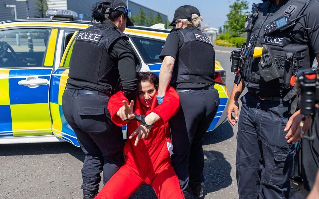 Rahmeh Aladwan is arrested near the front gates of the Elbit Systems Filton site.  Credit Milo Chandler/Alamy Live News
