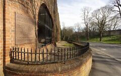 General view along the south-west wall of the Fossbank Car Park, showing the Jewbury Cemetery Plaque in the foreground, commemorating the site of the medieval Jewish cemetery of York. © Historic England Archive-