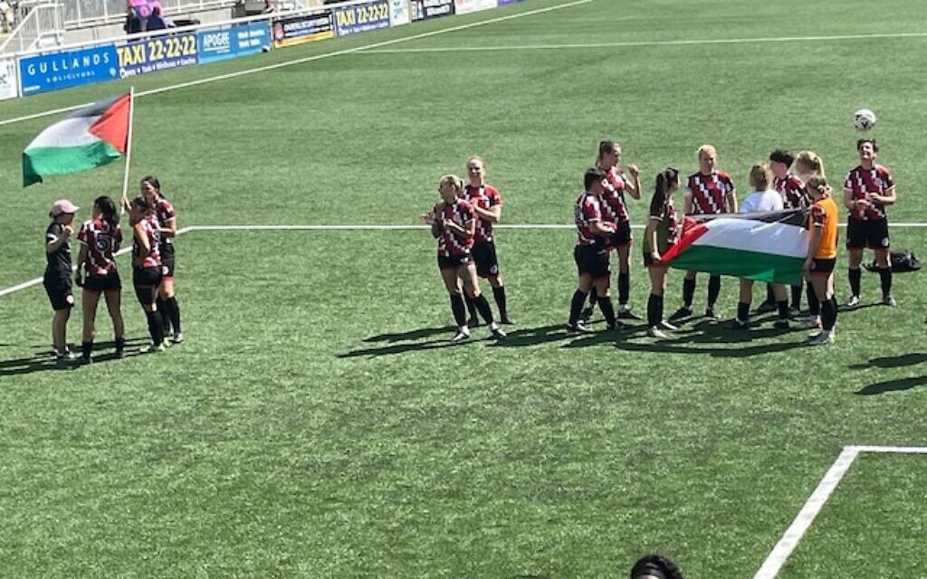 Clapton CFC Women hold Palestine flags on the pitch before cup final abandonment. Photo Credit: X