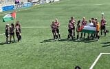Clapton CFC Women hold Palestine flags on the pitch before cup final abandonment. Photo Credit: X