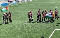 Clapton CFC Women hold Palestine flags on the pitch before cup final abandonment. Photo Credit: X Clapton CFC Women hold Palestine flags on the pitch before cup final abandonment. Photo Credit: X