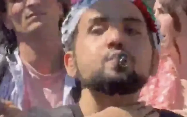 A protester makes a threatening gesture toward Israel’s delegation during the Eurovision parade in Basel. Screenshot: X