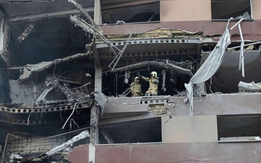 Firefighters work the scene of an explosion at a residence compound in northern Tehran, Iran, Friday, June 13, 2025. (AP Photo/Vahid Salemi)