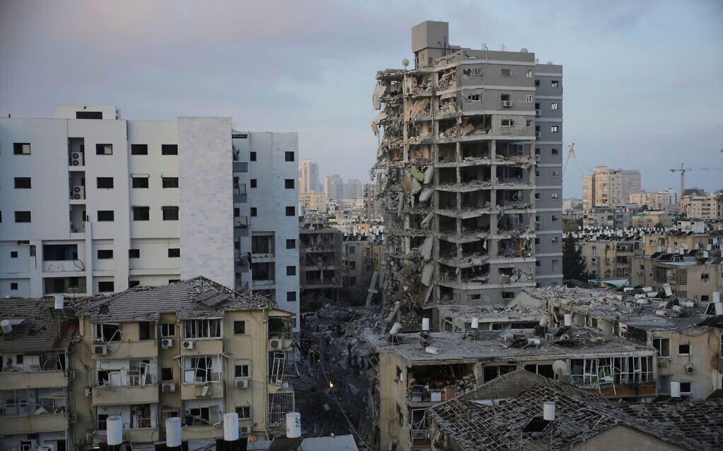 Israeli security forces inspect destroyed buildings that were hit by a missile fired from Iran, near Tel Aviv, Israel, Sunday, June 15, 2025.