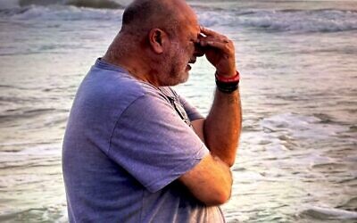 Yoram Yehudai weeps for his son Ron on the beach in India (credit: Adi Fainaru Kotler)