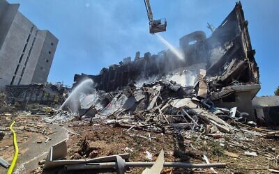 Firefighters douse the remains of Prof. Eldad Tzahor’s lab at the Weizmann Institute, destroyed in an Iranian missile strike. Photo: Prof. Eldad Tzahor/X