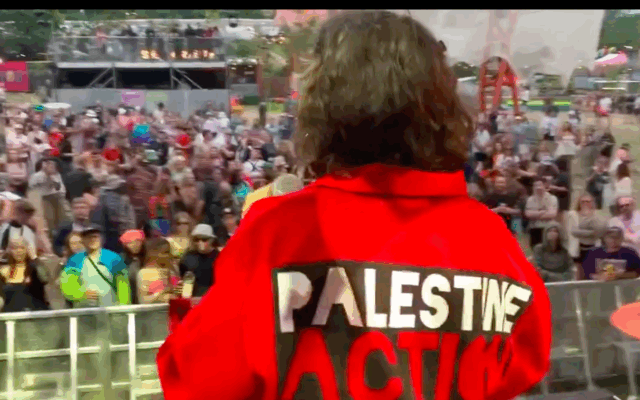 A Palestine Action member addresses a crowd from a Glastonbury stage, prior to the group's proscription as a terrorist organisation