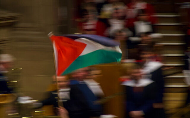 A graduate waves a Palestinian flag during a ceremony at the University of Edinburgh, 11 July 2025. Photo taken from X