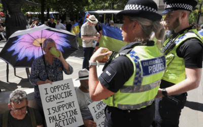Police speak to protesters holding placards supporting Palestine Action. Credit: Twitter/@Africalix