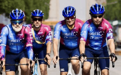Ofer Calderon (left) rides with Israel -Premier Tech teammates along the Champs-Élysées ahead of the Tour de France finale. Photo credit: Noa Arnon / Israel–Premier Tech