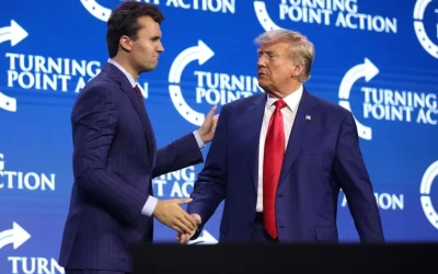 Kirk and President Donald Trump speaking with attendees at a Turning Point Action Conference in 2023. Credit: Wikipedia
