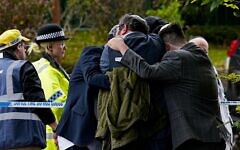 Members of the Jewish community comfort each other near to the Heaton Park Hebrew Congregation synagogue in Crumpsall, Manchester Members of the Jewish community comfort each other near to the Heaton Park Hebrew Congregation synagogue in Crumpsall, Manchester