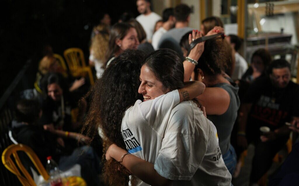 Relatives and supporters of Israeli hostages held by Hamas in the Gaza Strip celebrate after the announcement that Israel and Hamas have agreed to the first phase of a peace plan, as they gather at a plaza known as the hostages square in Tel Aviv, Israel, Thursday, Oct. 9, 2025. (AP Photo/Emilio Morenatti)