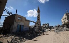 Palestinians walk past destroyed buildings as displaced residents return to their homes in the in al-Zahra area, north of the Nuseirat refugee camp, in the central Gaza Strip. Via Times of Israel Palestinians walk past destroyed buildings as displaced residents return to their homes in the in al-Zahra area, north of the Nuseirat refugee camp, in the central Gaza Strip. Via Times of Israel