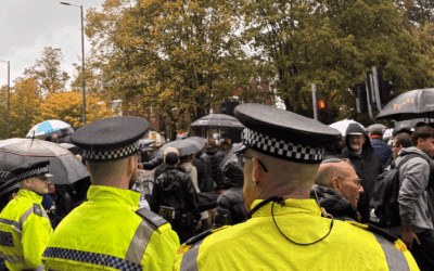 Police officers watch over crowds gathered outside Heaton Park Synagogue during the Manchester vigil for Yom Kippur attack victims.