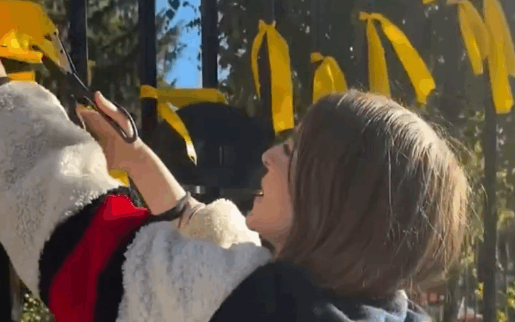 Nadia Yahlom cutting down hostage ribbons