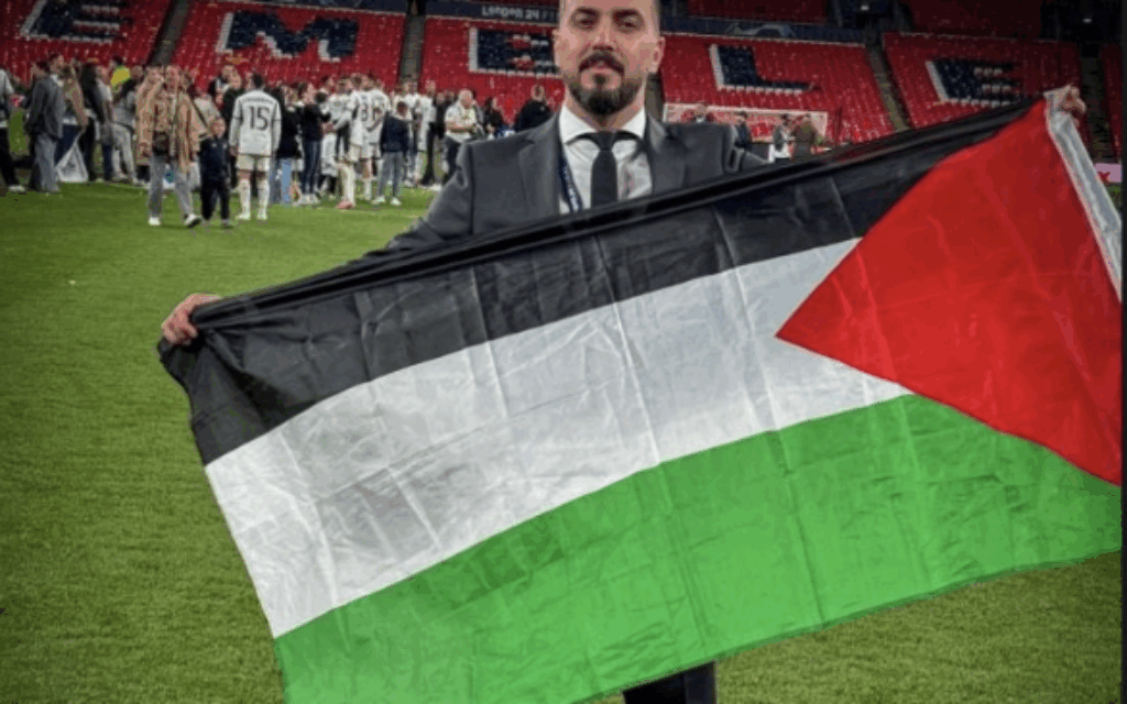 Ibrahim Khadra holding a Palestinian flag on the Wembley pitch after the Champions League Final. Image: David Collier
