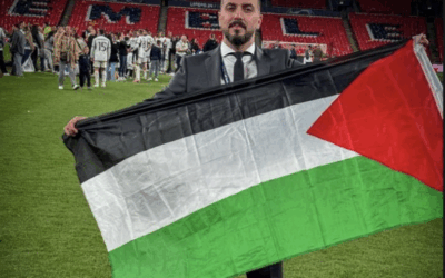 Ibrahim Khadra holding a Palestinian flag on the Wembley pitch after the Champions League Final. Image: David Collier