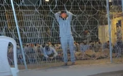 Palestinian detainees held behind fencing at the IDF’s Sde Teiman detention facility in southern Israel. Photo: Wikipedia Palestinian detainees held behind fencing at the IDF’s Sde Teiman detention facility in southern Israel. Photo: Wikipedia