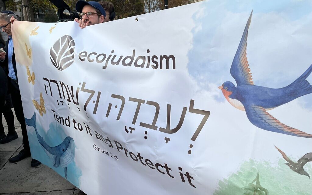 EcoJudaism supporters hold a banner reading “Tend to it and Protect it” at the Kol for Climate vigil in Parliament Square.
Credit: EcoJudaism