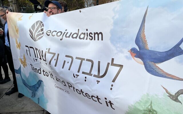 EcoJudaism supporters hold a banner reading “Tend to it and Protect it” at the Kol for Climate vigil in Parliament Square.
Credit: EcoJudaism