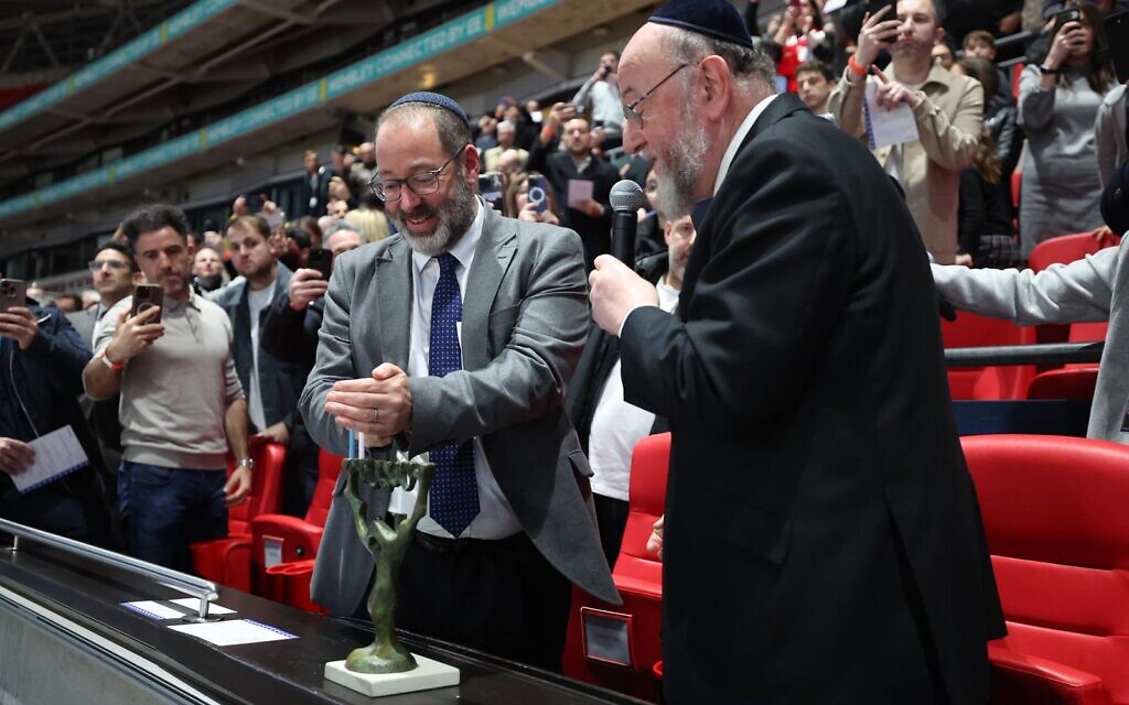 Chief Rabbi Ephraim Mirvis and Rabbi Josh Levy light the Chanukah menorah during a ceremony at Wembley Stadium. Credit: FA