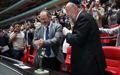 Chief Rabbi Ephraim Mirvis and Rabbi Josh Levy light the Chanukah menorah during a ceremony at Wembley Stadium. Credit: FA