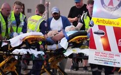 Emergency workers transport a person on a stretcher after a reported shooting at Bondi Beach in Sydney, Sunday, Dec. 14, 2025. (AP Photo/Mark Baker)