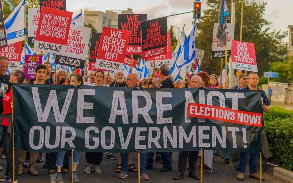 Demonstrators from diverse backgrounds on Horev Boulevard in the city of Haifa in the north of Israel, a regular site of protests, carry signs in Hebrew, Arabic, and English, united in opposition to the government's policies. They differentiate themselves from the ultra-Orthodox and illiberal elements in the government by highlighting that 
they are pro-democratic, contributing citizens. Photo by: Ran Dembo
Haifa, May 4, 2024