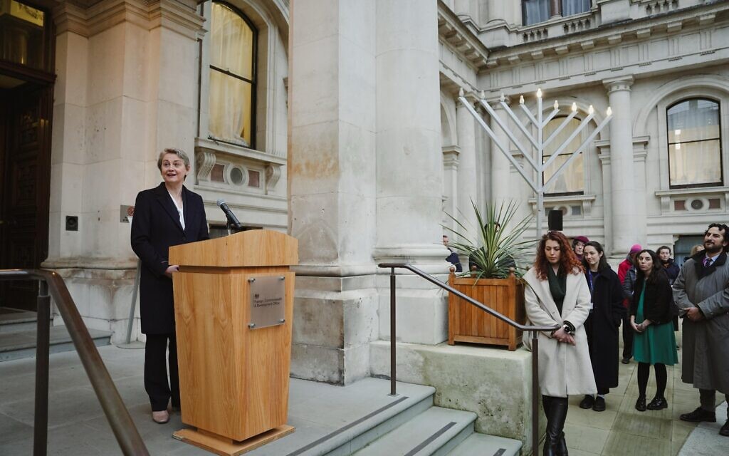 Yvette Cooper speaks at FCDO with Chanukiah in courtyard