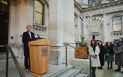 Yvette Cooper speaks at FCDO with Chanukiah in courtyard
