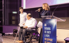 Itai and his father Ephraim share their story on stage as host Mili Avital addresses guests at Simcha LeYeled’s London fundraiser. Itai and his father Ephraim share their story on stage as host Mili Avital addresses guests at Simcha LeYeled’s London fundraiser.