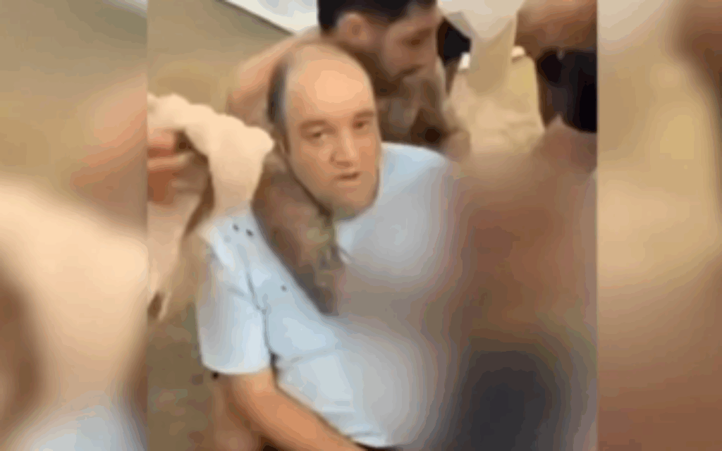 Ahmed el-Ahmed being treated for his injuries after tackling one of the terrorists