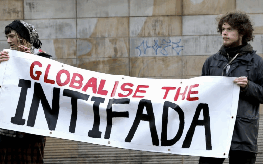 Pro-Palestinian demonstrators hold a banner reading “Globalise the intifada”. Credit:
American Jewish Committee (AJC)